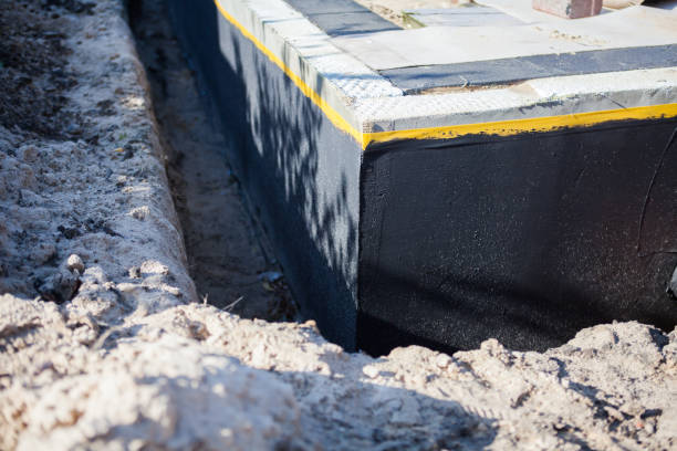 Professional Basement Waterproofing technician working in Arlington, VA